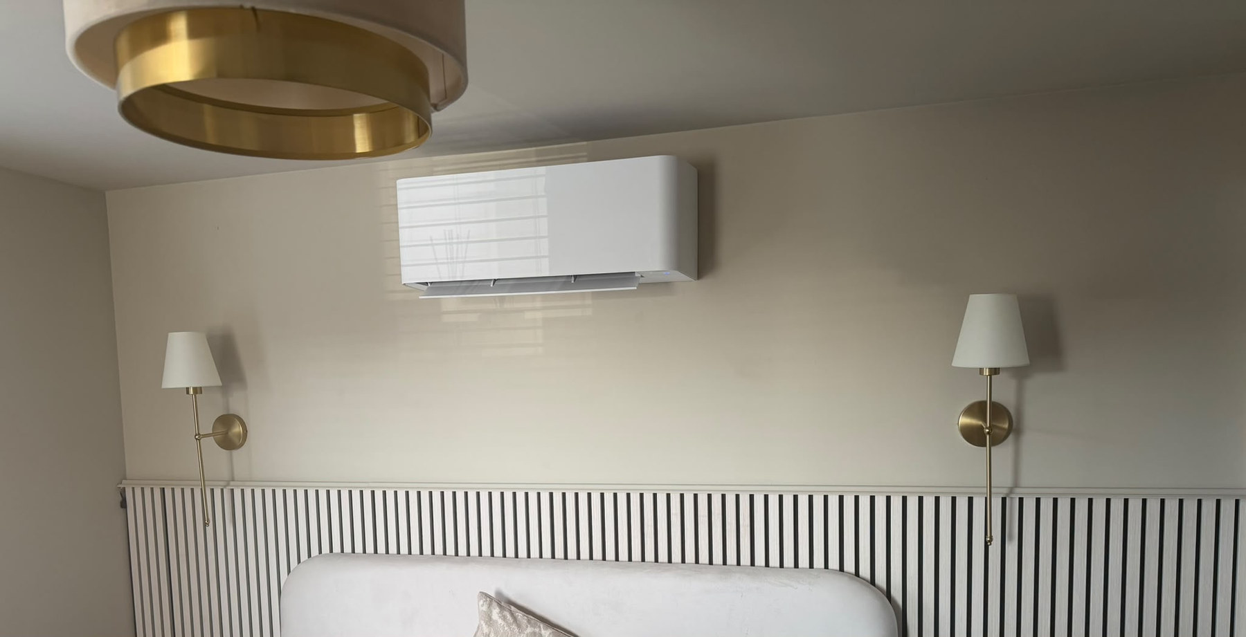 Wall-mounted air conditioning unit in a bedroom